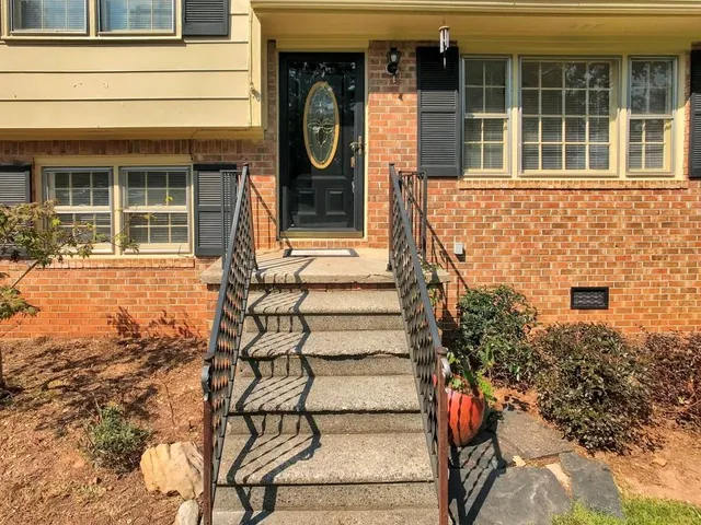 a front view of a house with a window and brick walls