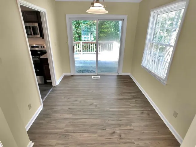 wooden floor in an empty room with a window