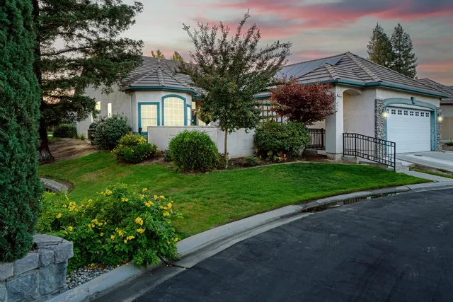 a front view of a house with a garden