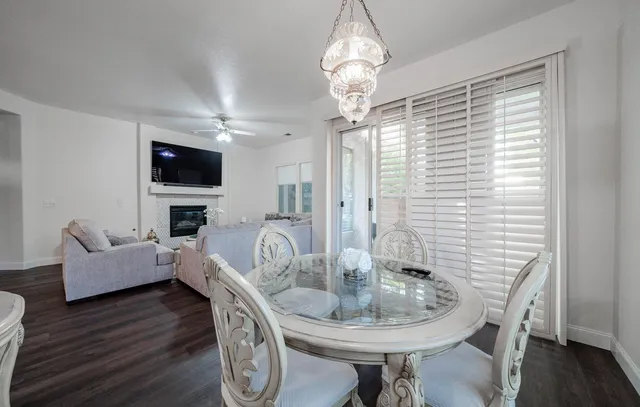 a kitchen with stainless steel appliances a white stove top oven a sink dishwasher and a refrigerator with wooden floor