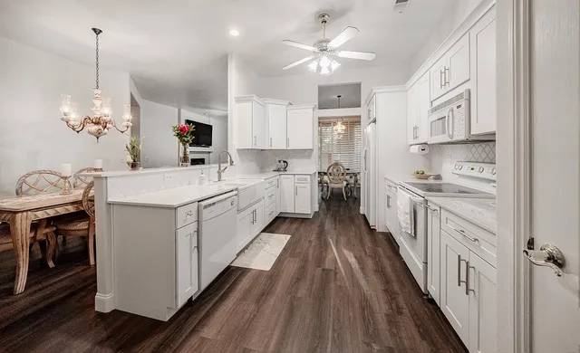 a view of a dining room with furniture and chandelier