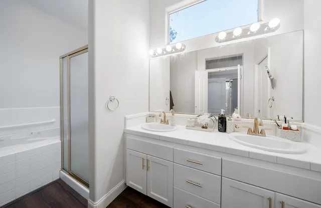 a spacious bedroom with a bed and a chandelier