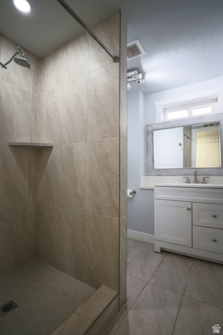 422 West Buckeye Reef Road Leeds, UT 84746 - Photo 29 of 47 Full bathroom featuring a shower stall, vanity, and light tile patterned flooring