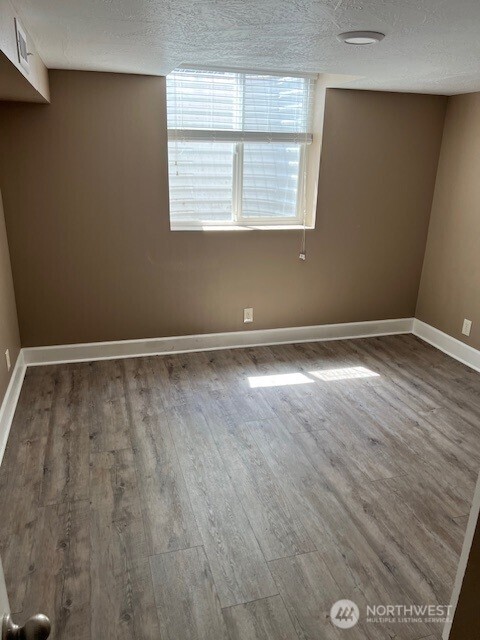 618 Cardinal Drive Walla Walla, WA 99362 - Photo 16 of 31 an empty room with wooden floor and windows