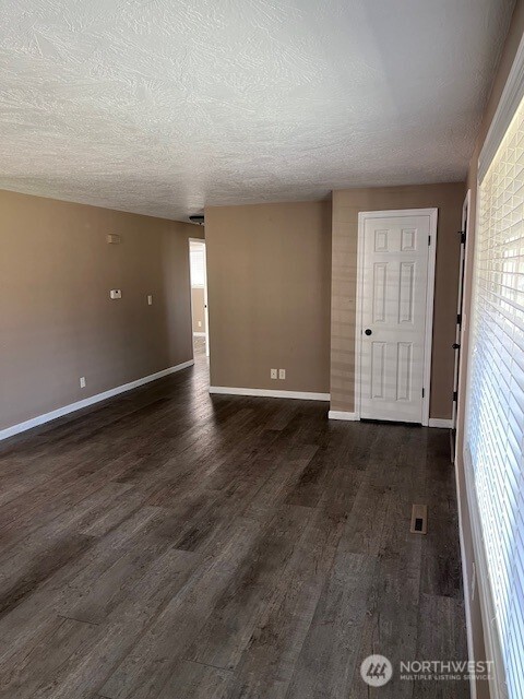 618 Cardinal Drive Walla Walla, WA 99362 - Photo 22 of 31 an empty room with wooden floor and windows
