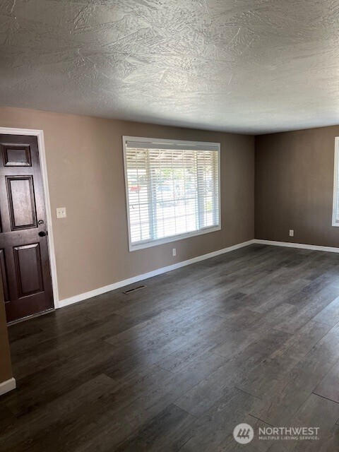 618 Cardinal Drive Walla Walla, WA 99362 - Photo 6 of 31 an empty room with wooden floor and windows