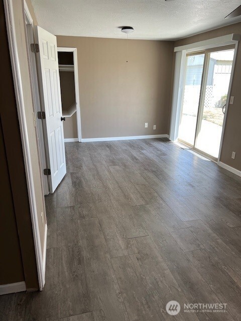 618 Cardinal Drive Walla Walla, WA 99362 - Photo 10 of 31 an empty room with wooden floor and windows