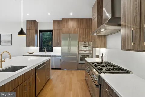 a kitchen with a sink stove and refrigerator