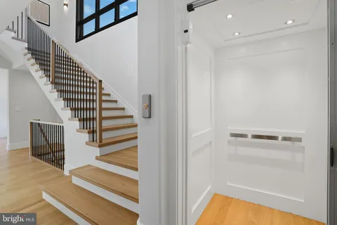 a view of entryway and hall with wooden floor