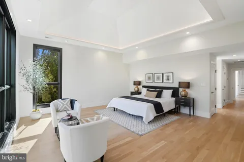 a spacious bedroom with a bed and a large window