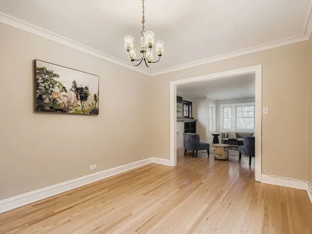 a view of a room with furniture wooden floor and a chandelier