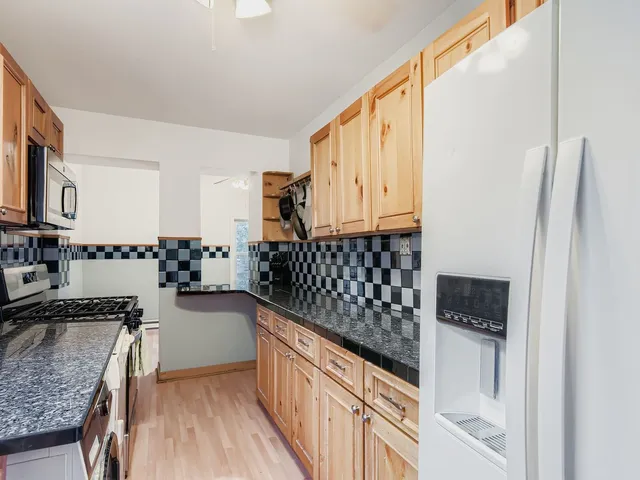 a kitchen with sink cabinets and stove top oven