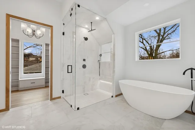 a view of a bathroom with a tub and shower