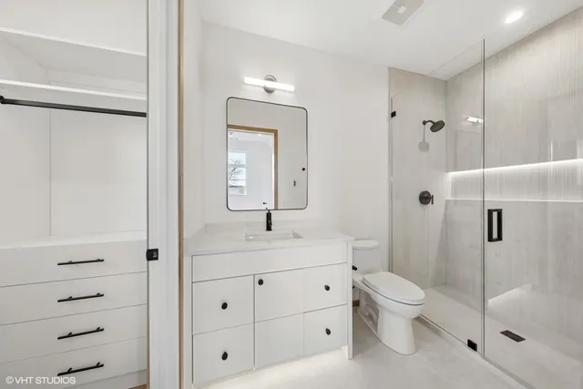 a bathroom with a granite countertop sink toilet and shower