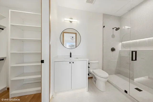 a bathroom with a toilet a sink and shower