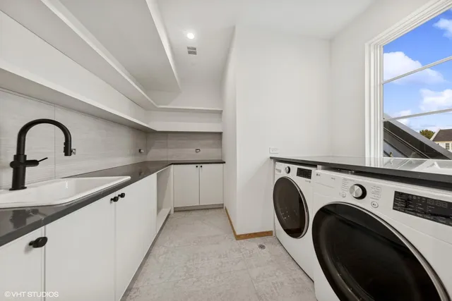 a view of a kitchen with sink washer and dryer