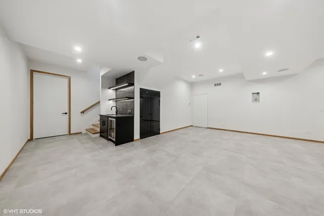 a view of an empty room with closet and a window
