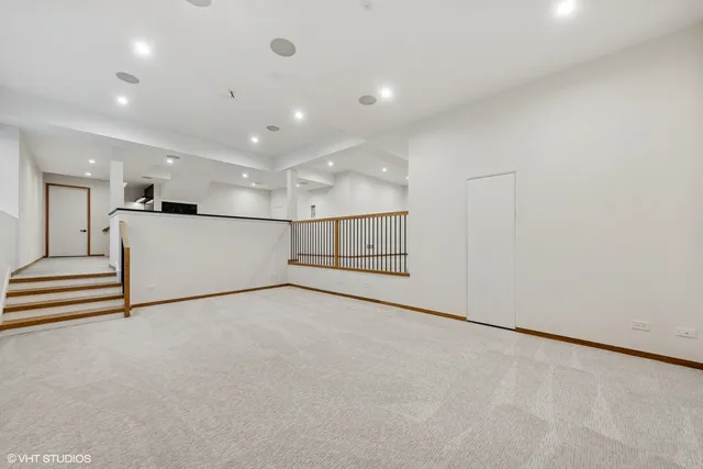 wooden floor in an empty room with a kitchen