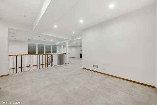 an empty room with a empty space and windows