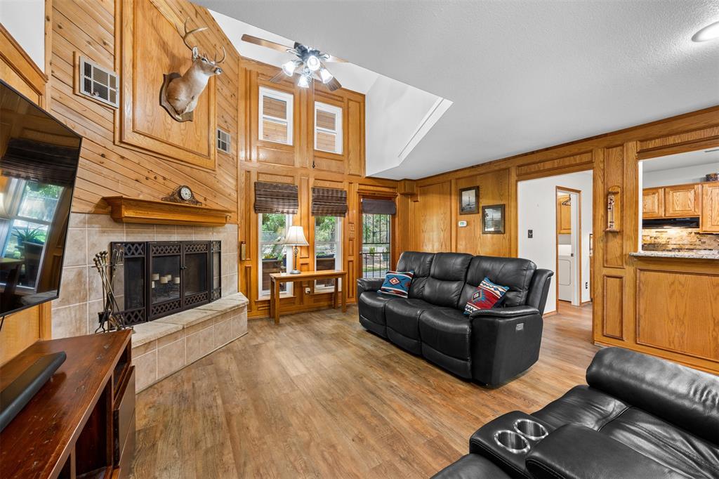 881 Wild Road Van Alstyne, TX 75495 - Photo 10 of 40 a living room with furniture a fireplace and a flat screen tv