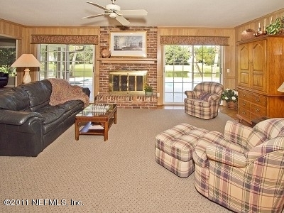 7540 Hollyridge Road Jacksonville, FL 32256 - Photo 12 of 31 Family room with fireplace & lake view