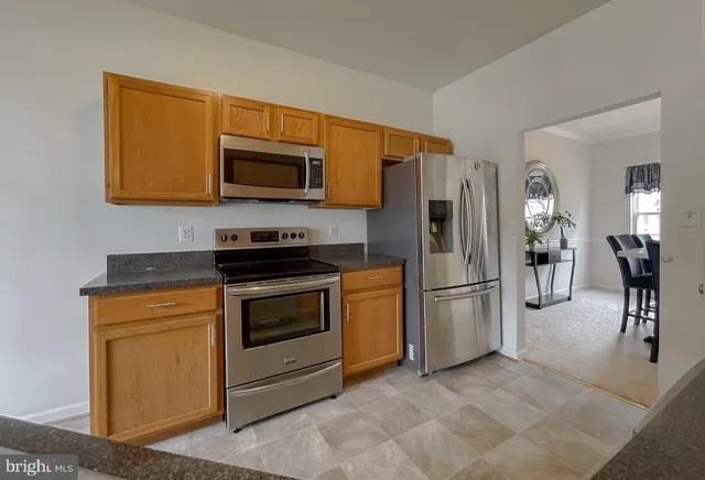 a kitchen with stainless steel appliances granite countertop a sink and cabinets