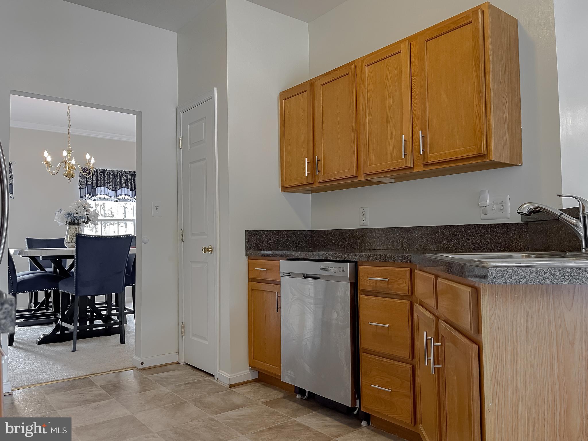 47162 Green Leaf Road Lexington Park, MD 20653 - Photo 19 of 50 a kitchen with stainless steel appliances granite countertop a sink and cabinets