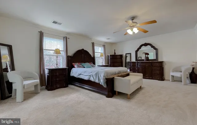 a spacious bedroom with a bed and a chandelier