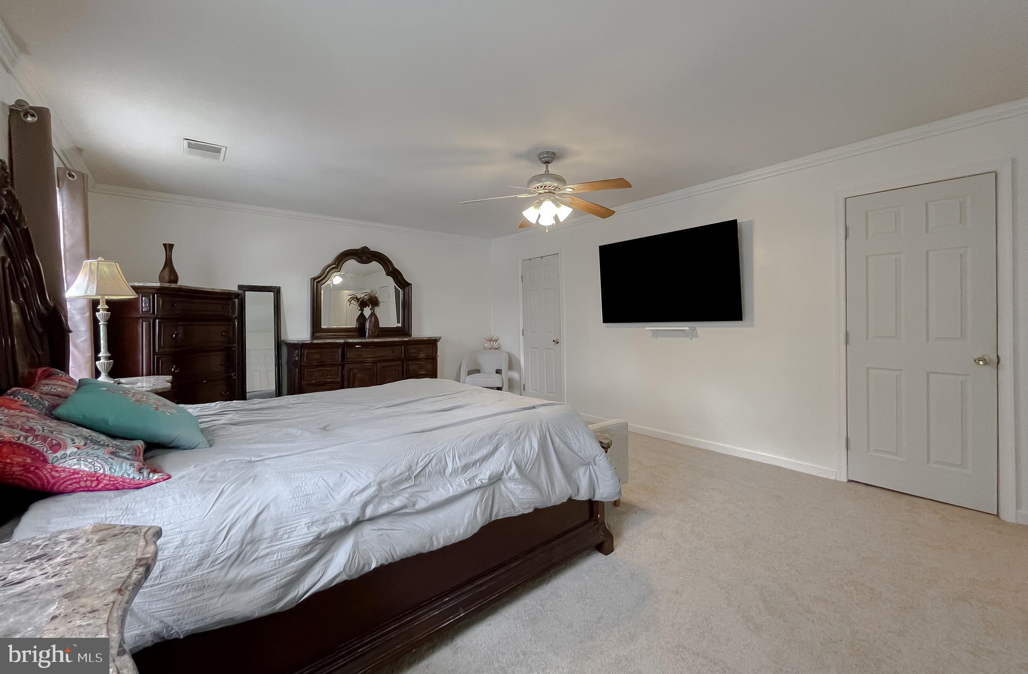 47162 Green Leaf Road Lexington Park, MD 20653 - Photo 27 of 50 a bedroom with a bed and a flat screen tv