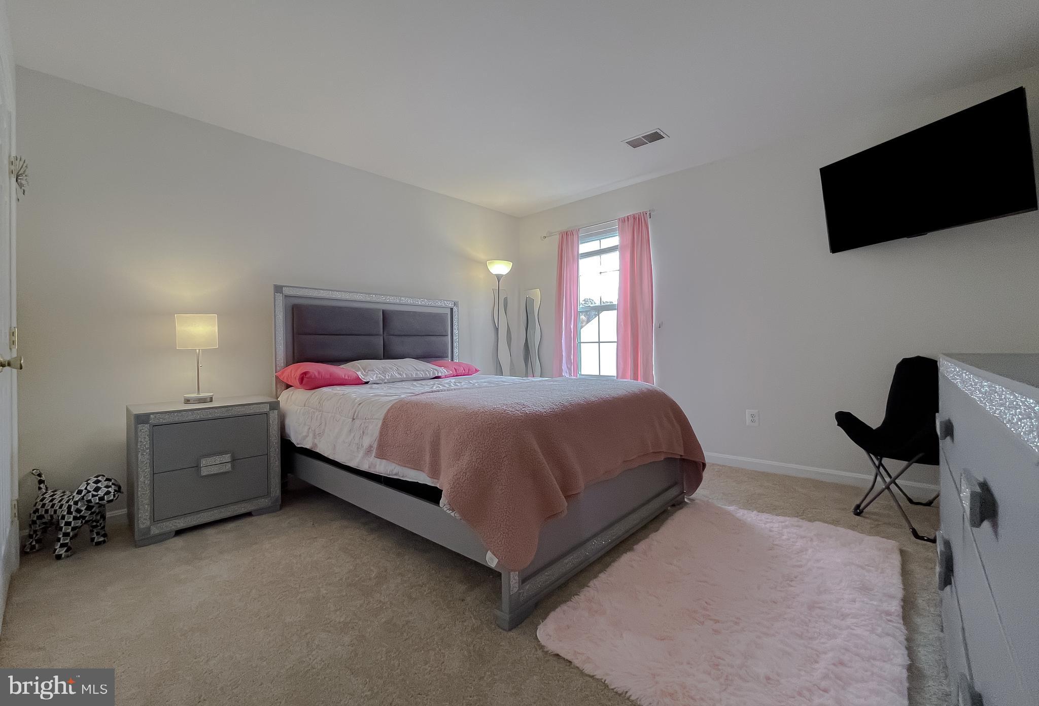 47162 Green Leaf Road Lexington Park, MD 20653 - Photo 35 of 50 a bedroom with a bed and a flat screen tv