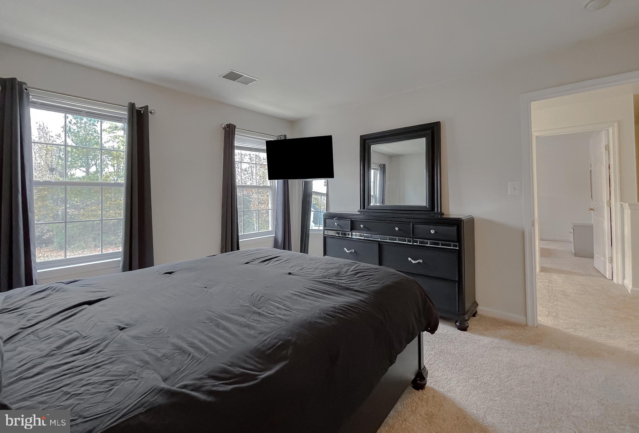 47162 Green Leaf Road Lexington Park, MD 20653 - Photo 37 of 50 a bedroom with a bed and a flat screen tv