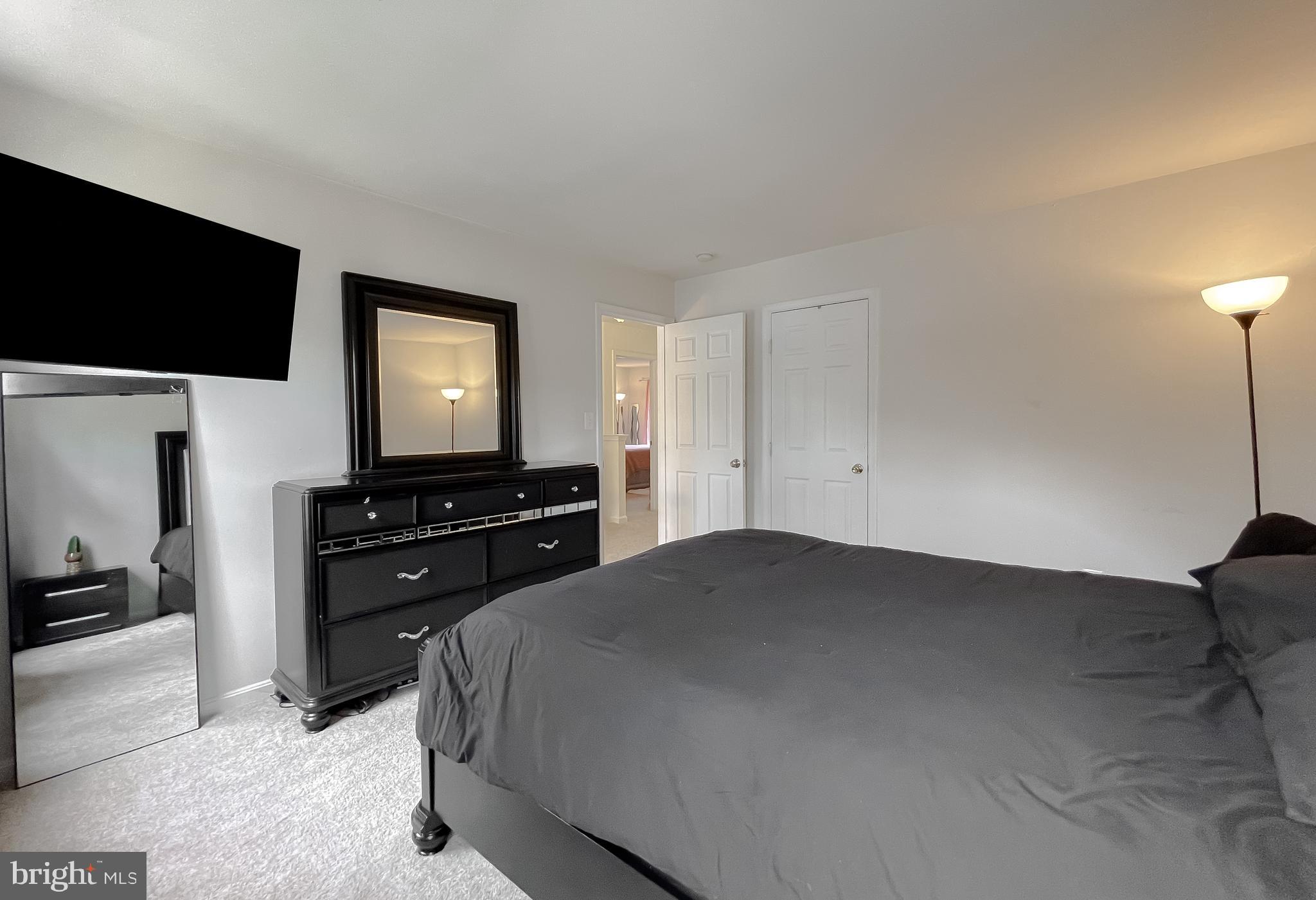 47162 Green Leaf Road Lexington Park, MD 20653 - Photo 38 of 50 a bedroom with a bed and a flat screen tv