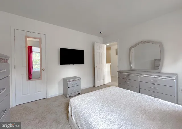 a bedroom with a large bed and a large window