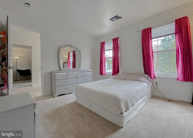 a bedroom with a bed and dresser