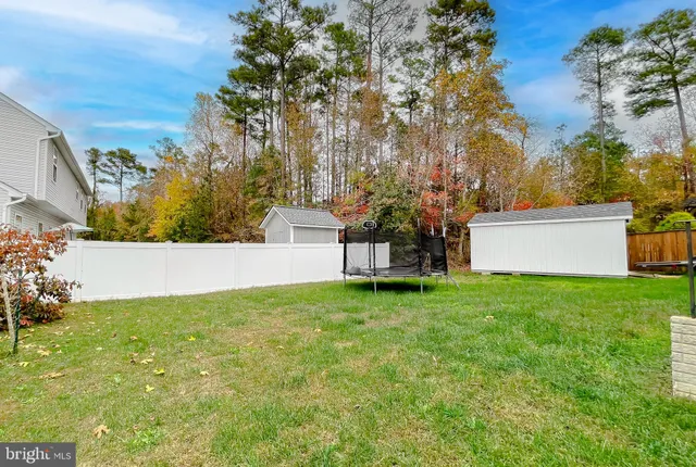 a view of house with backyard