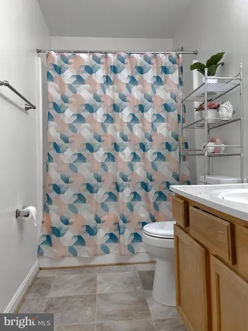 a bathroom with a sink toilet vanity and tub