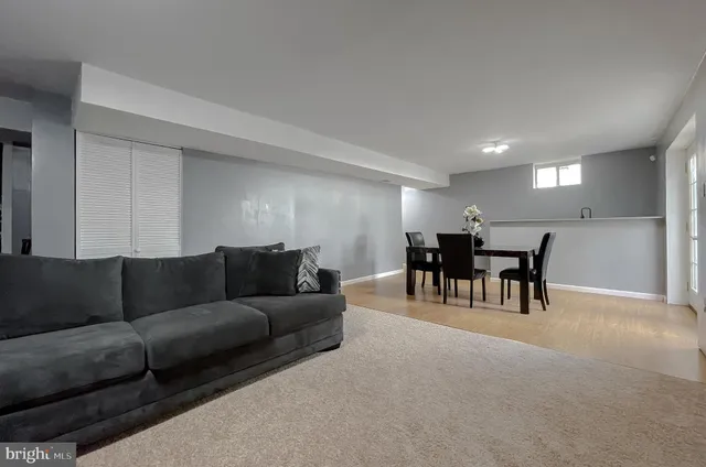 a view of a dining room with furniture and a potted plant