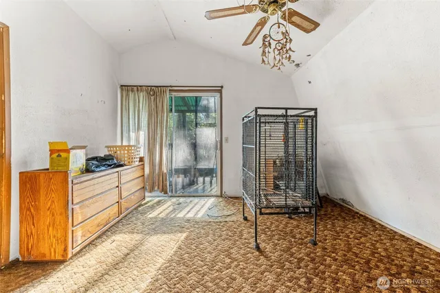 a spacious bedroom with a bed and a chandelier