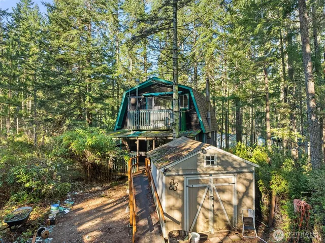 a roof deck with table and chairs under an umbrella
