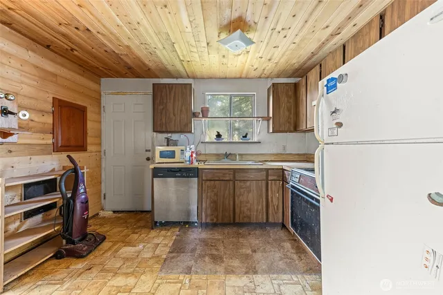 a kitchen with a sink cabinets and stainless steel appliances