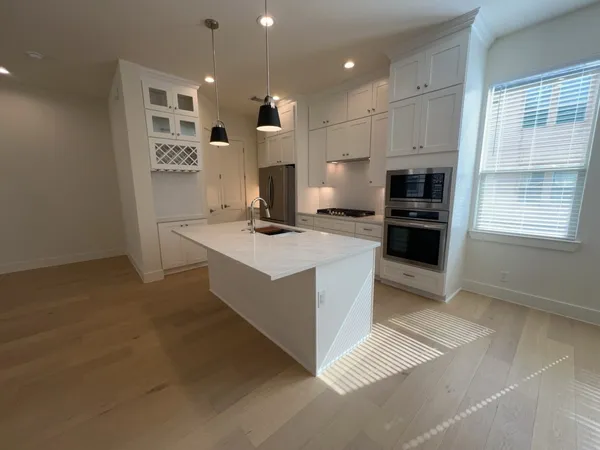 a kitchen that has a stove a sink and a refrigerator