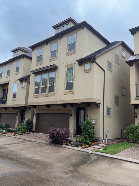 10607 Enclave Shadows Court Houston, TX 77043 - Photo 1 of 29 a front view of a house with a yard and garage