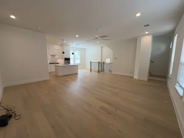 a view of a kitchen with refrigerator and window
