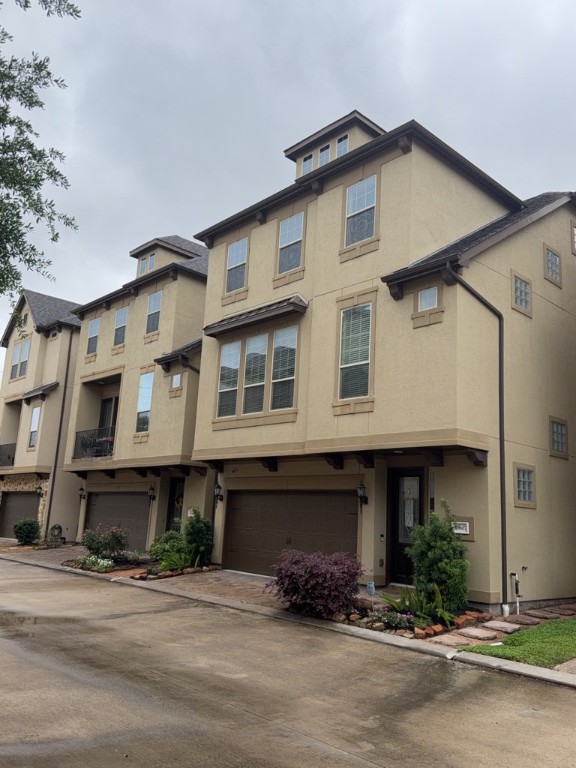 10607 Enclave Shadows Court Houston, TX 77043 - Photo 2 of 29 a front view of a house with yard