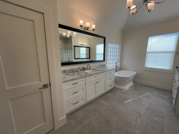 a bathroom with a double vanity sink a toilet and mirror