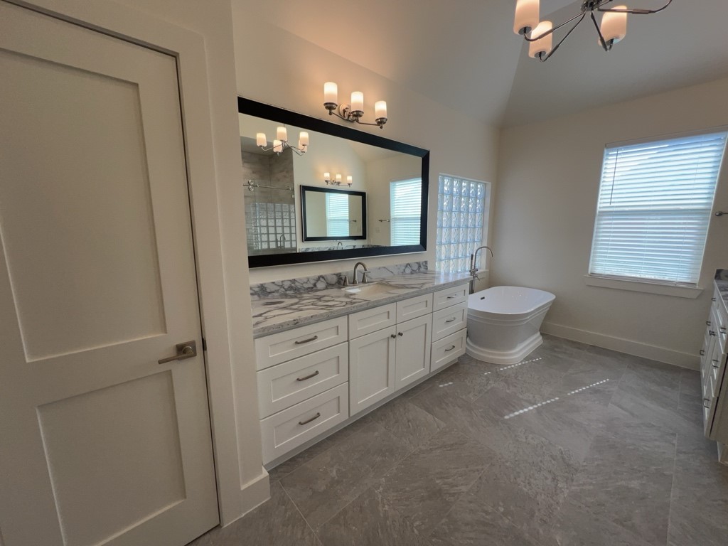 10607 Enclave Shadows Court Houston, TX 77043 - Photo 7 of 29 a bathroom with a double vanity sink a toilet and mirror
