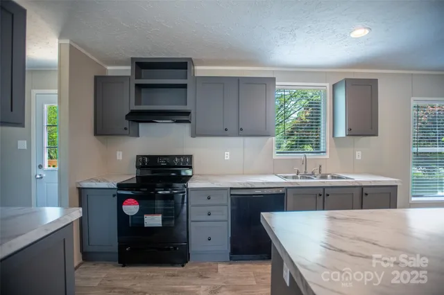 a kitchen with stainless steel appliances granite countertop a refrigerator and a stove top oven