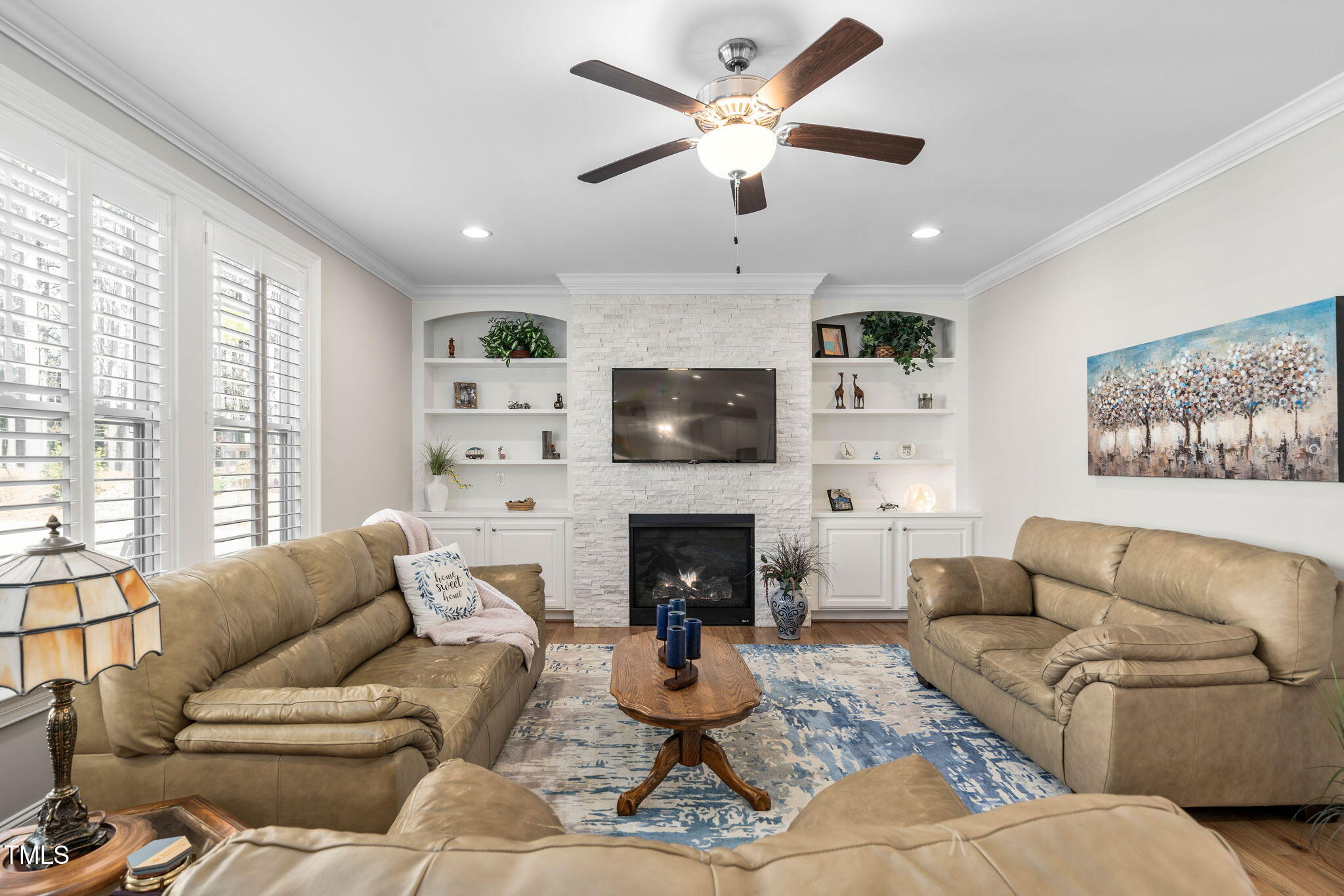 2461 Stonehenge Park Drive Raleigh, NC 27613 - Photo 14 of 72 a living room with furniture a fireplace and a large window