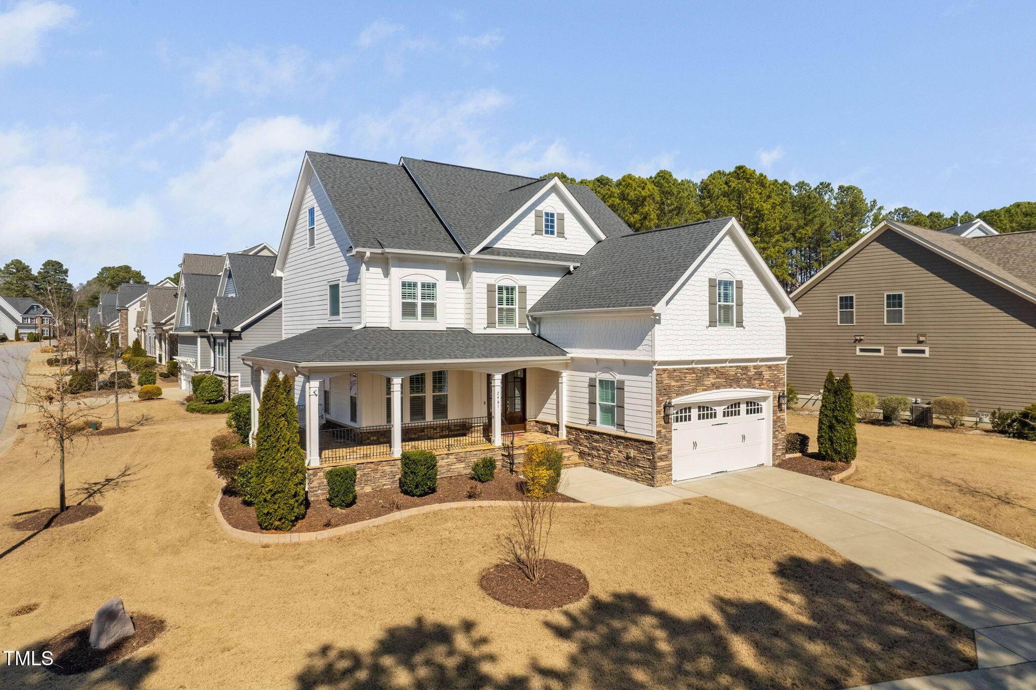 2461 Stonehenge Park Drive Raleigh, NC 27613 - Photo 2 of 72 a view of a white house with a swimming pool and porch