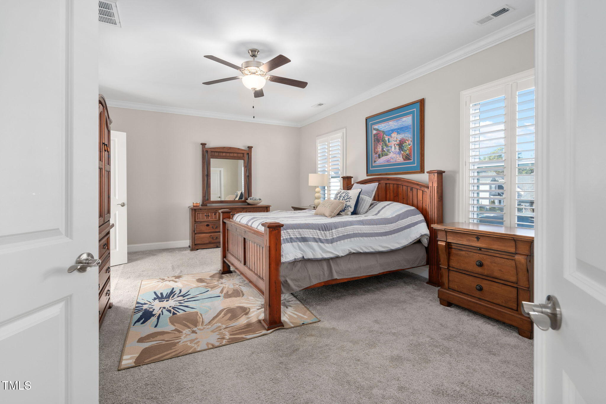 2461 Stonehenge Park Drive Raleigh, NC 27613 - Photo 24 of 72 a bedroom with a bed and a chandelier